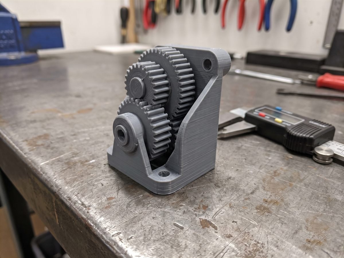 3D printed planetary gear reduction drive on a workshop bench